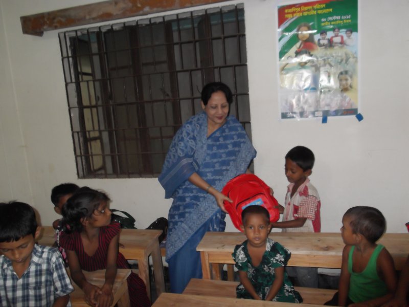 giving-school-bag-to-a-child-learner-at-cews-school-for-slum-children-in-dhaka-2
